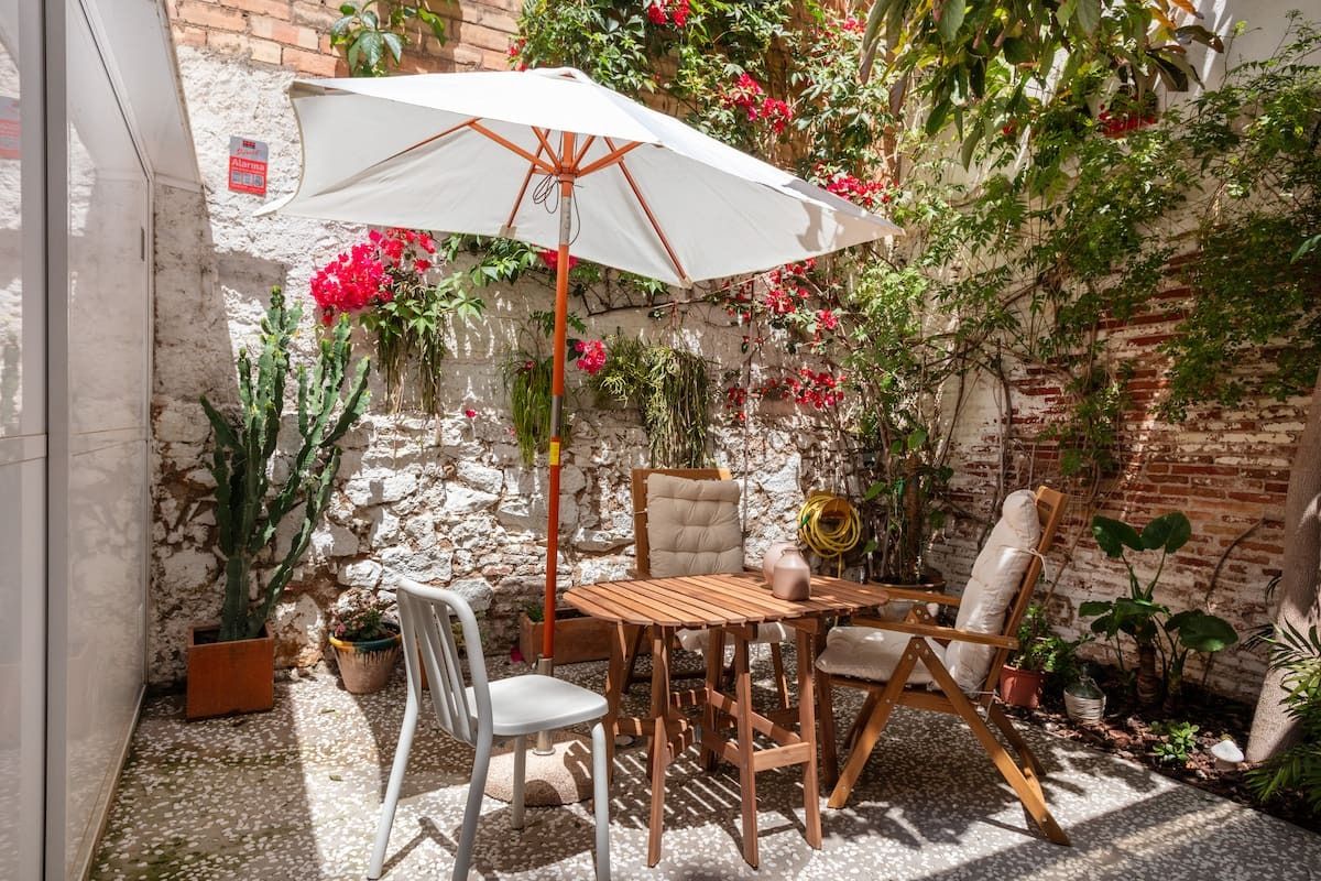 Images may contain plant architecture house housing terrace chair furniture interior design and table